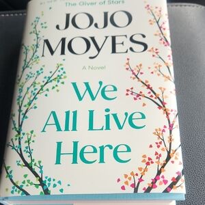 Hardcover Book We All Live Here By JOJO MOYES